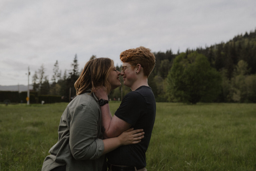 boy and girl almost kiss in a field