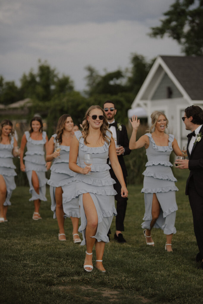bridesmaids cheer as they enter reception at Abeja winery wedding