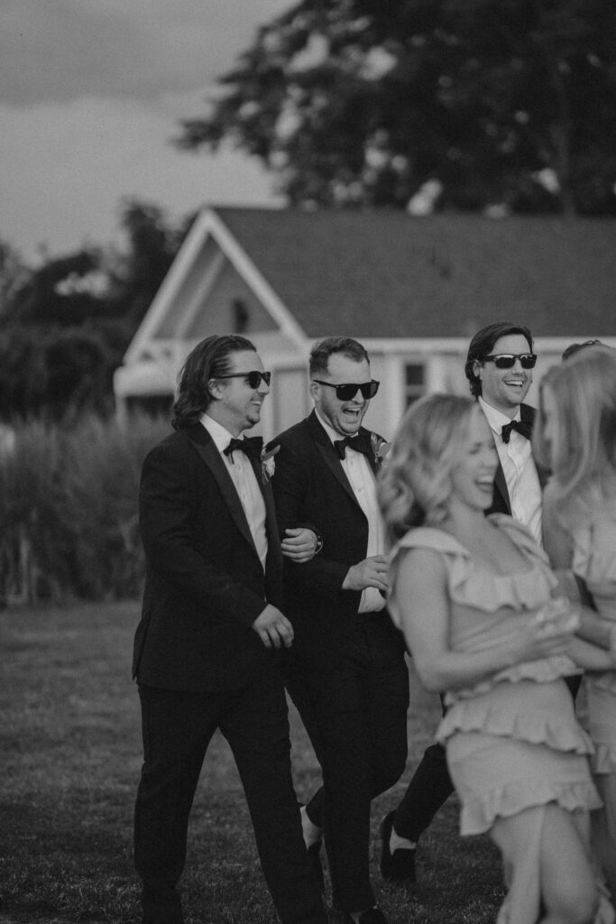 groomsmen laugh as they enter abeja winery wedding