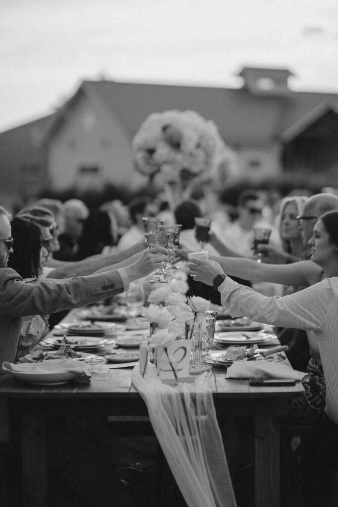 bridal party cheers over a table