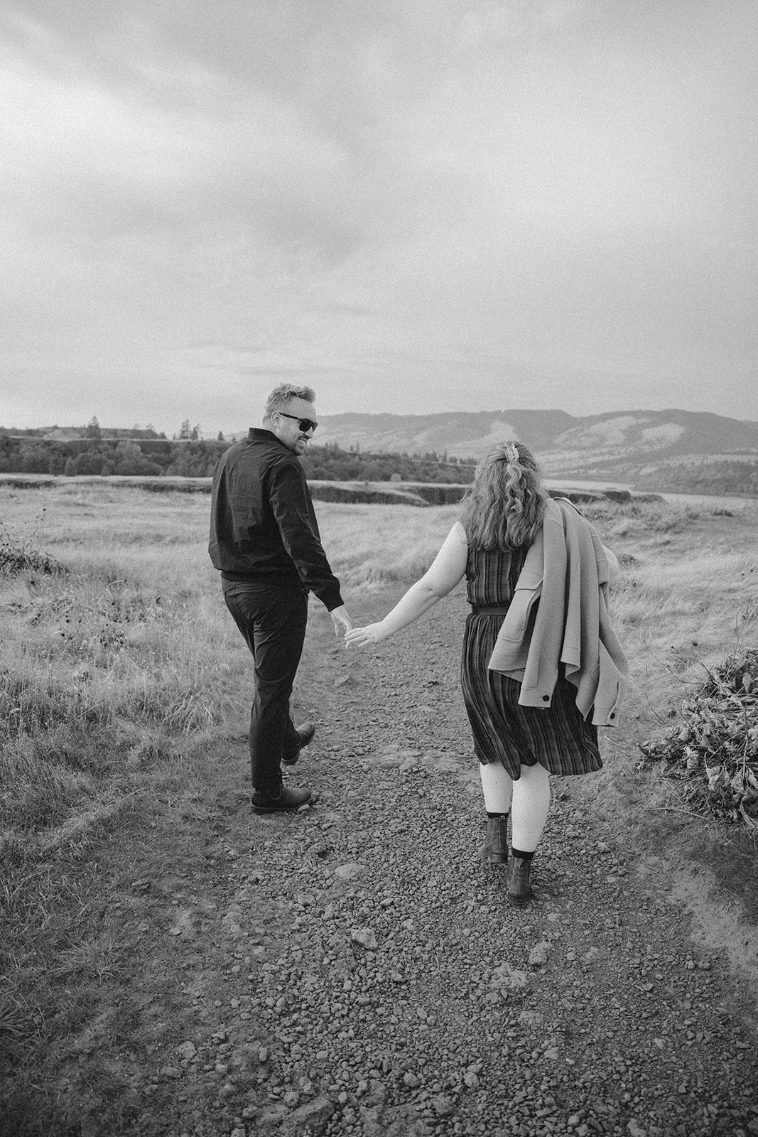 boy and girl walk along path at hood river photo shoot
